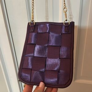 Ah dorned New York’s purple seat belt crossbody